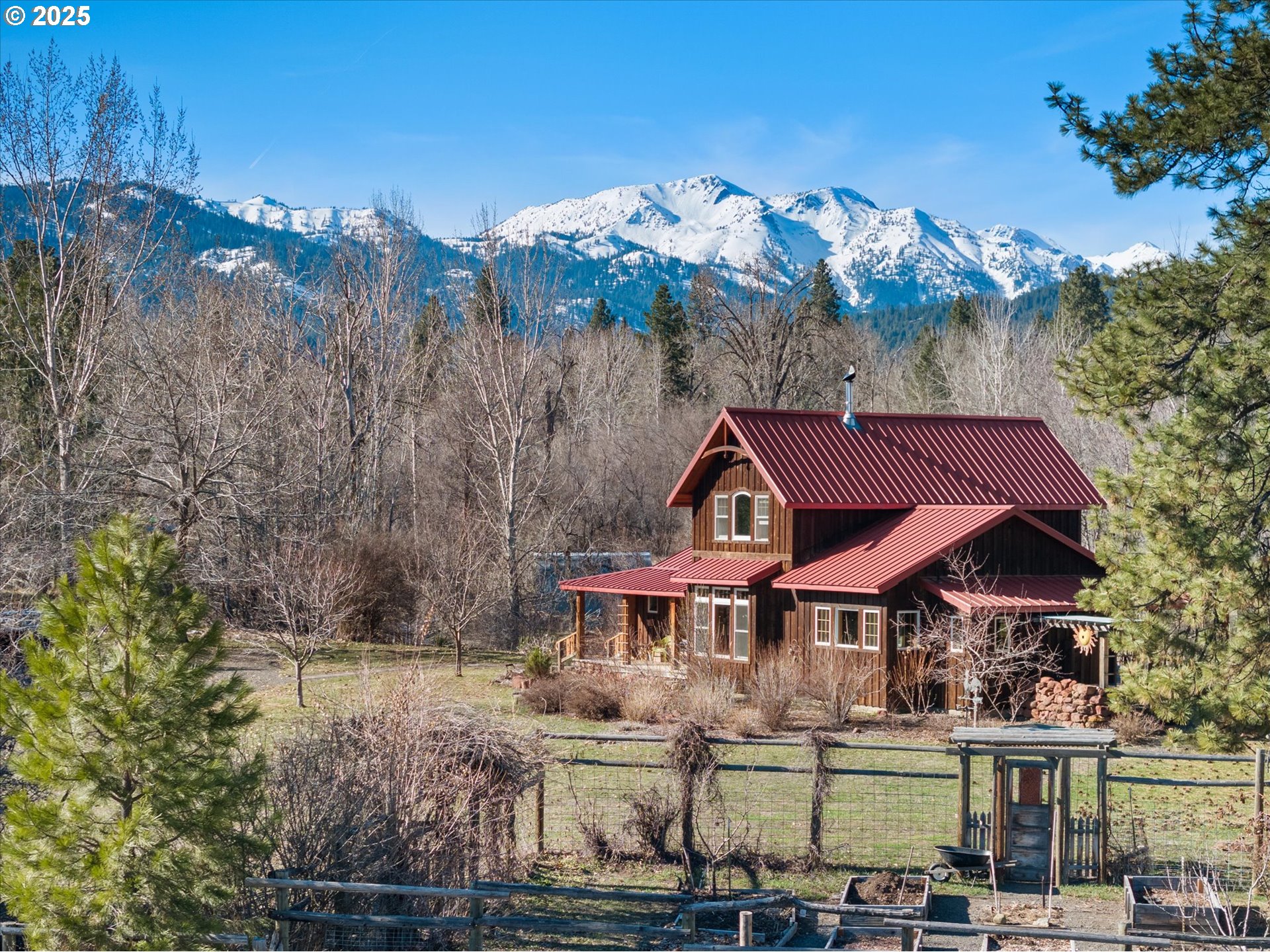 48303 Cornucopia Highway Halfway, OR 97834 - Photo 2 of 48 a front view of a house with a yard and mountain view in back