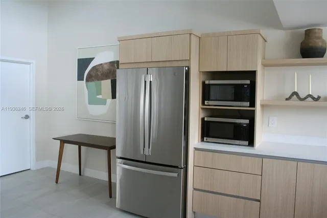 a kitchen with stainless steel appliances and refrigerator