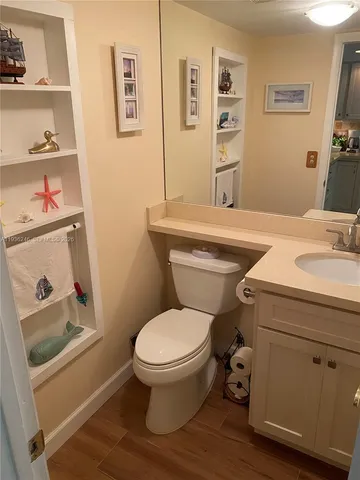 a bathroom with a toilet sink and mirror
