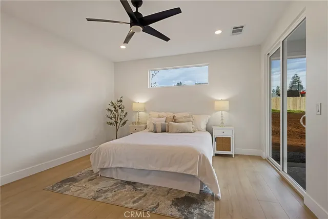 a bedroom with a large bed and a chandelier