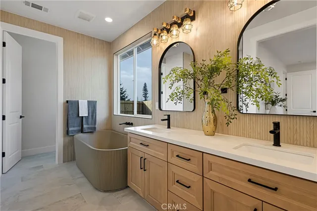 a bathroom with a double vanity sink and a mirror