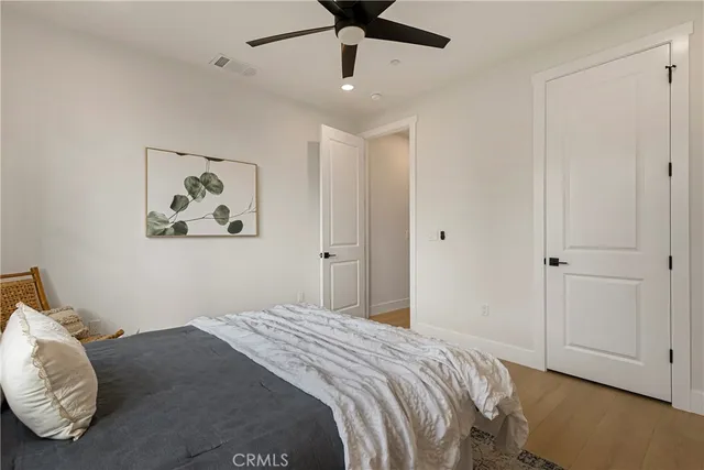 a bedroom with bed and a chandelier