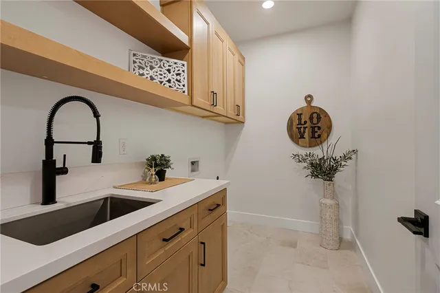 a view of a kitchen with a sink and cabinets