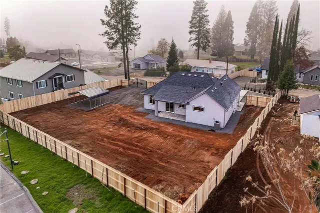 an aerial view of a house with a yard