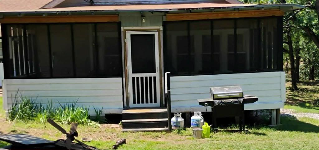 763 Frontier Street Bowie, TX 76230 - Photo 18 of 28 a backyard of a house with barbeque oven