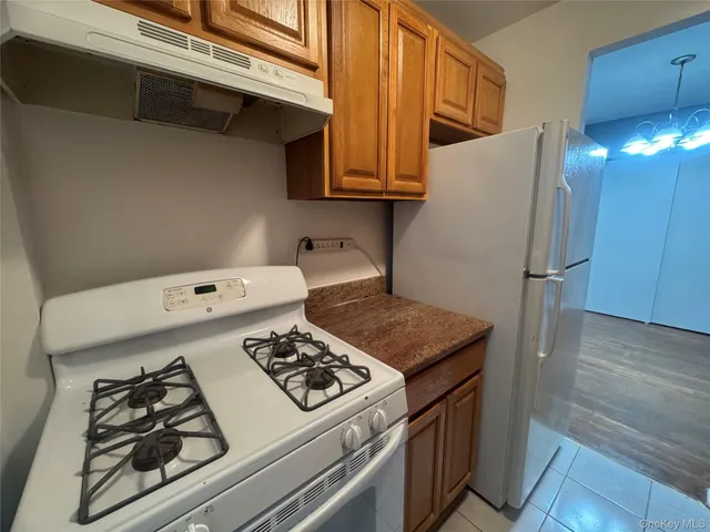 a kitchen with stainless steel appliances granite countertop a stove and a refrigerator