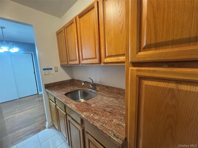 a kitchen with granite countertop sink and cabinets