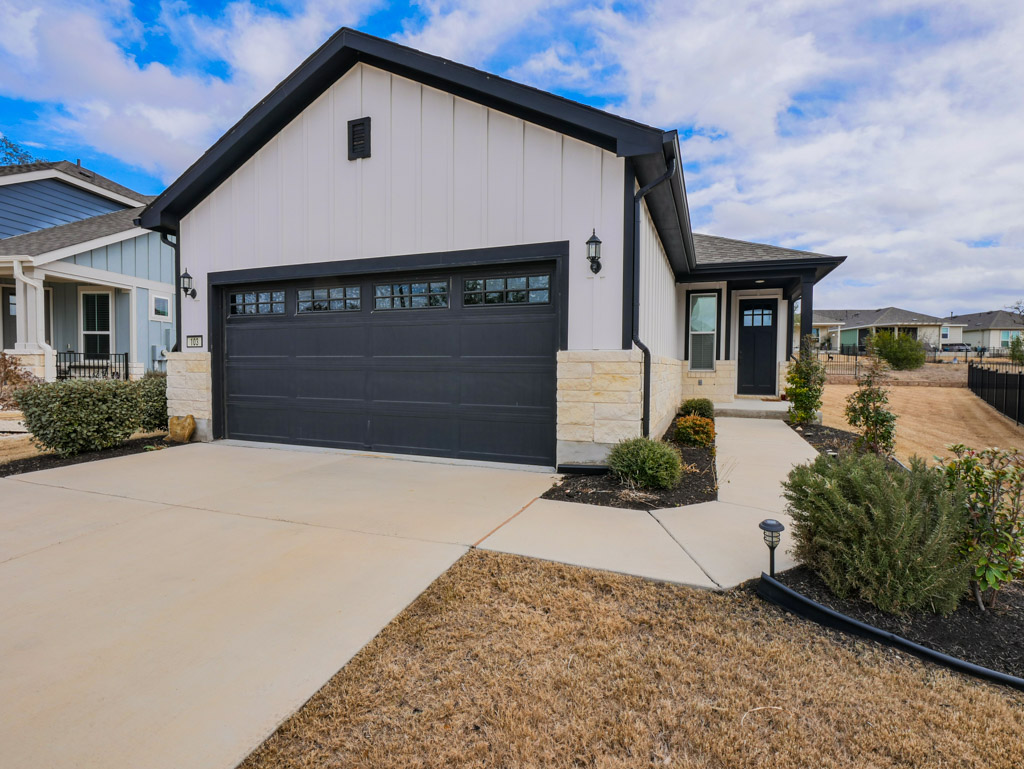 a front view of a house with a yard and garage