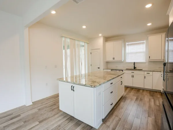 a kitchen with sink cabinets and wooden floor