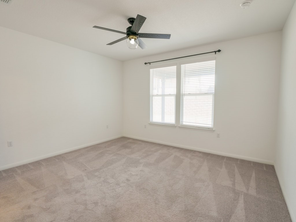 103 Kitty Hawk Road Georgetown, TX 78633 - Photo 19 of 34 an empty room with a window and a fan