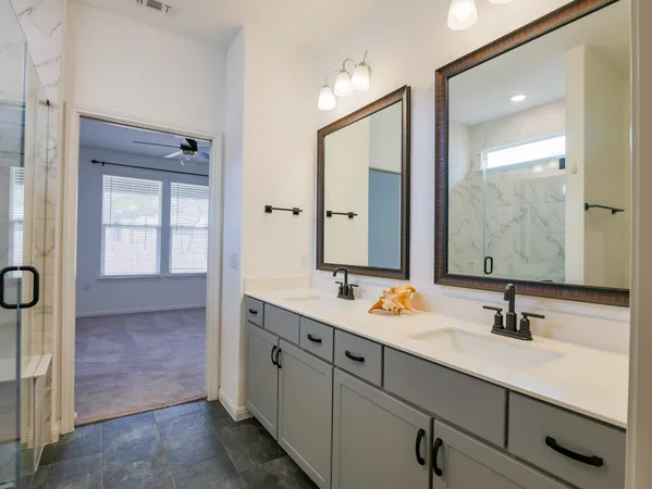 a en suite bathroom with double sink and a mirror