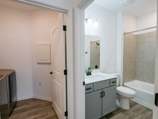 a bathroom with a sink a toilet and a bathtub