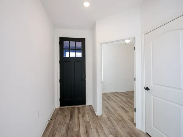 a view of a hallway with wooden floor