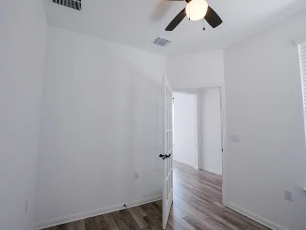 a view of a room with wooden floor
