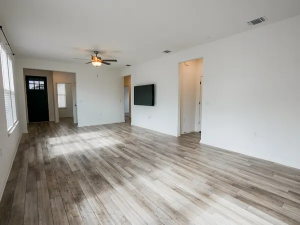 wooden floor in an empty room with a window