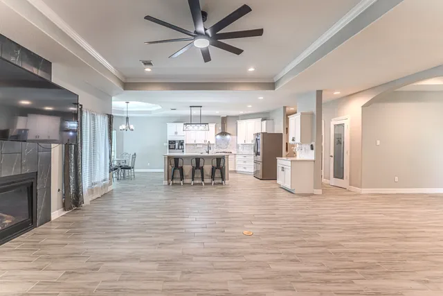 a living room with furniture and kitchen view