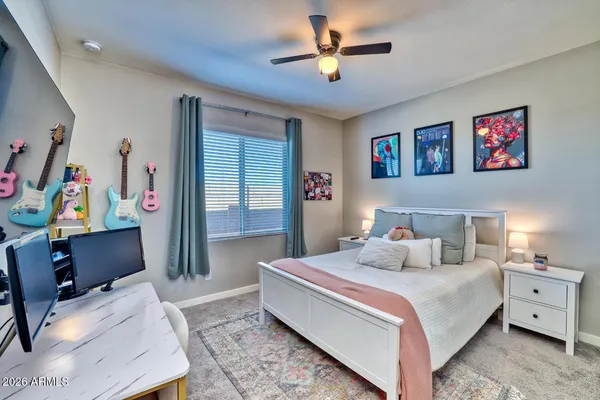 a bedroom with a bed and a desk