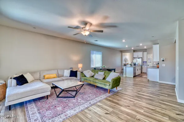 a living room with furniture and wooden floor