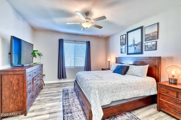 a bedroom with a large bed and a chandelier