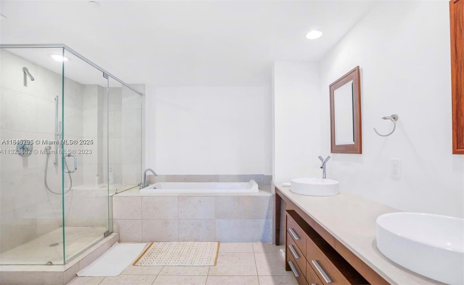 475 Brickell Avenue, Unit 4909 Miami, FL 33131 - Photo 8 of 9 a bathroom with a granite countertop sink a toilet and shower