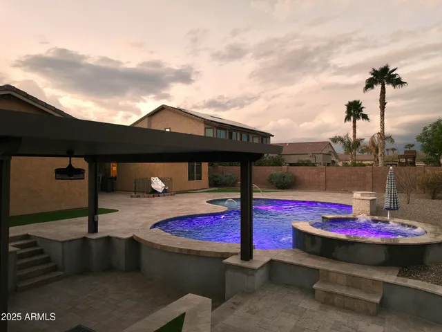 a view of swimming pool with red chairs