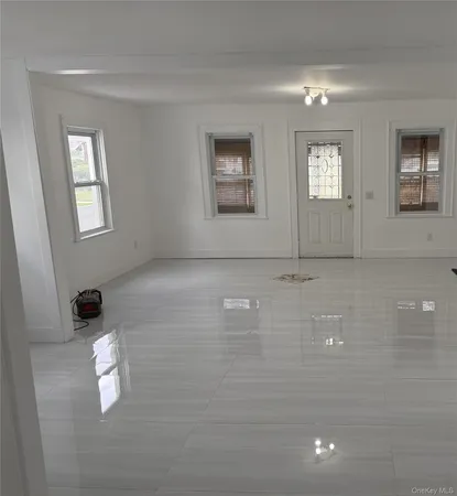 a large kitchen with a large counter top cabinets and stainless steel appliances