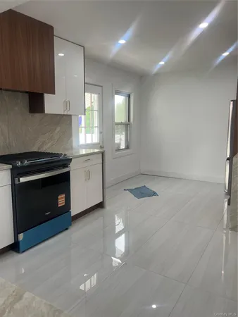 a kitchen with granite countertop a refrigerator and a sink