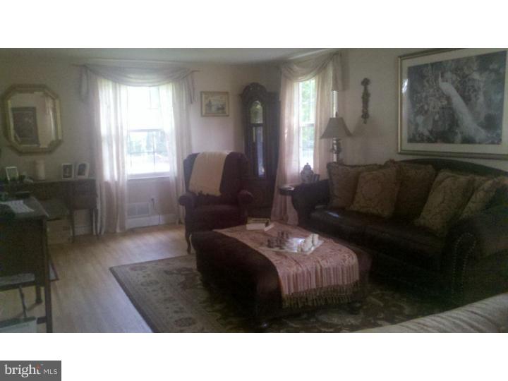 129 Kitty Hawk Road Cherry Hill, NJ 08034 - Photo 8 of 12 a living room with furniture and a fireplace