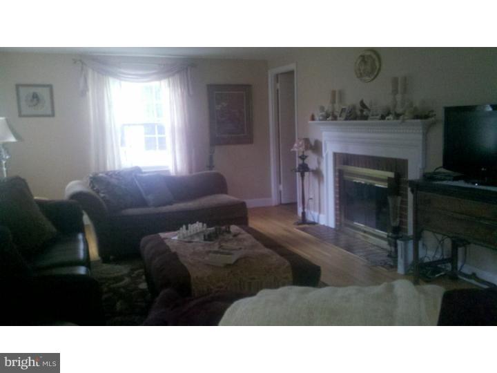 129 Kitty Hawk Road Cherry Hill, NJ 08034 - Photo 9 of 12 a living room with furniture a flat screen tv and a fireplace