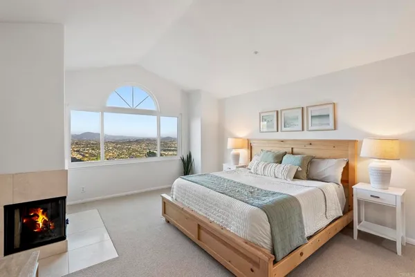 a bedroom with a bed and a fireplace