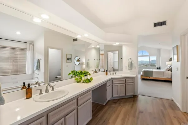 a large white kitchen with a sink and dish washer