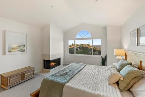 a bedroom with a bed and a fireplace