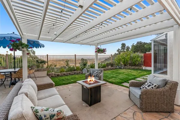 a view of a patio with couches table and chairs and a big yard