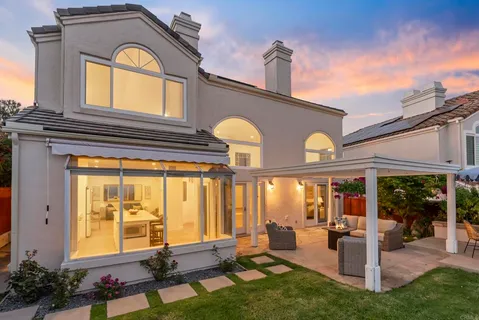 a front view of a house with a swimming pool and outdoor seating
