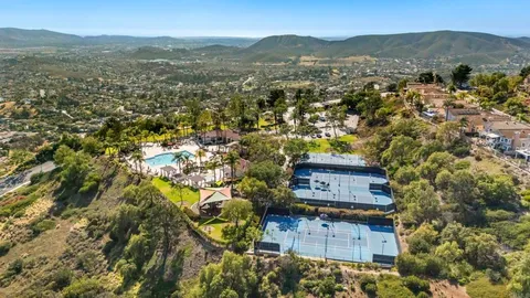 an aerial view of a house with a mountain