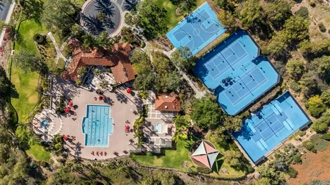 an aerial view of a residential houses with outdoor space