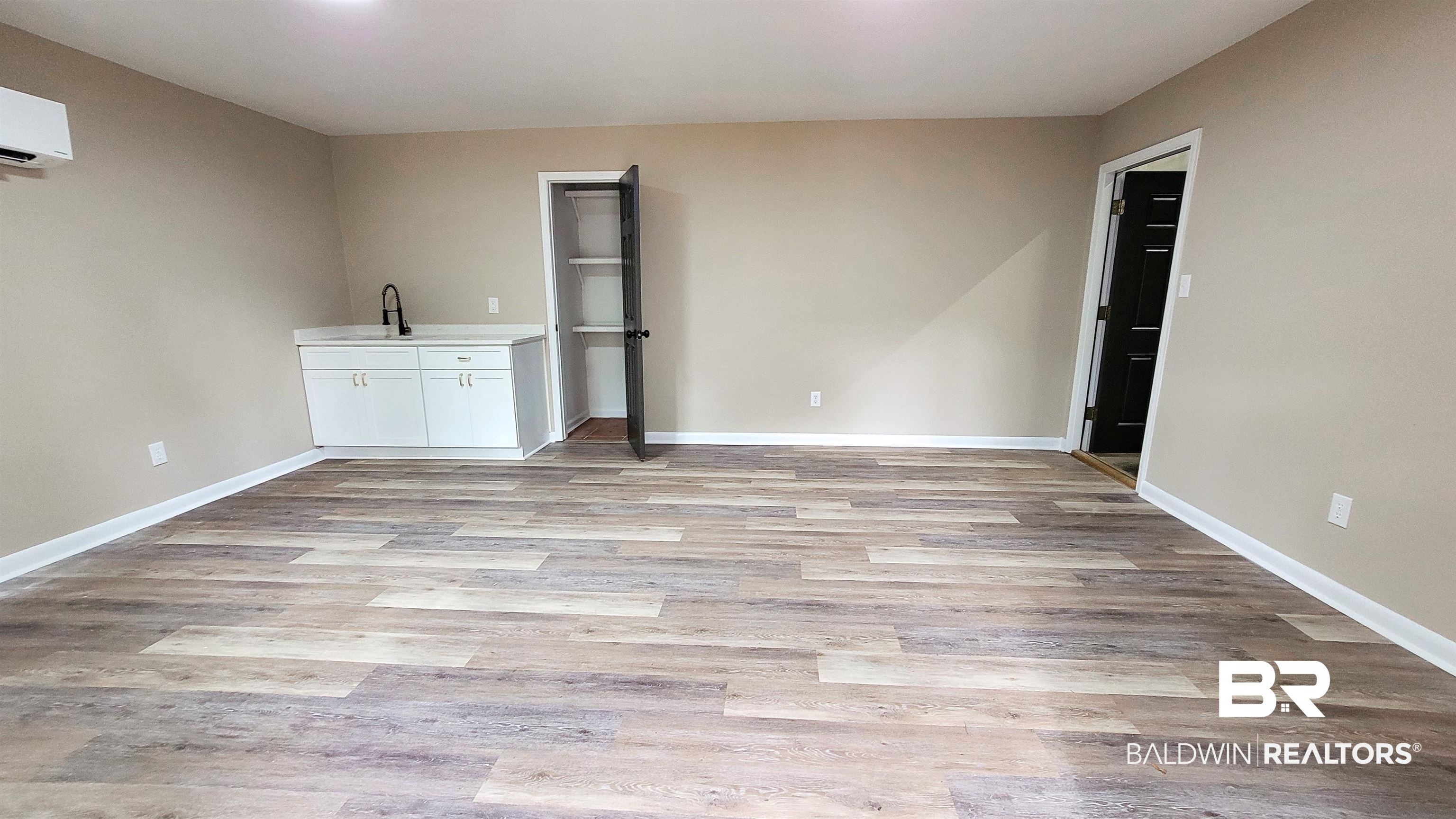 22711 Highway 98 Foley, AL 36535 - Photo 9 of 74 Unfurnished living room with light wood finished floors and a wall mounted AC