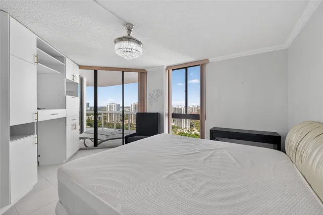 a bedroom with a large bed and a chandelier