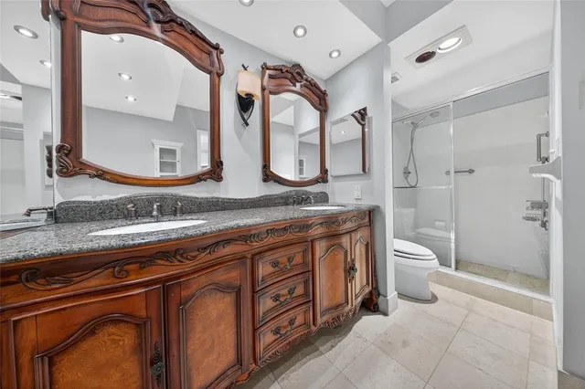 a white toilet next to a bathroom