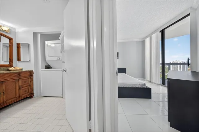 a large bed sitting in a bedroom next to a window