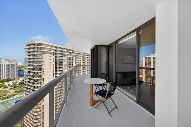 a view of a balcony with chair and a table