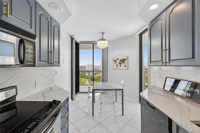 a kitchen with a refrigerator a stove top oven a sink and dishwasher