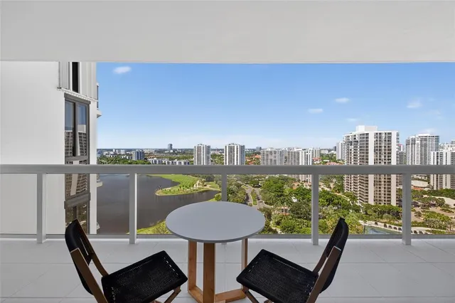 a view of a balcony with a table and chairs