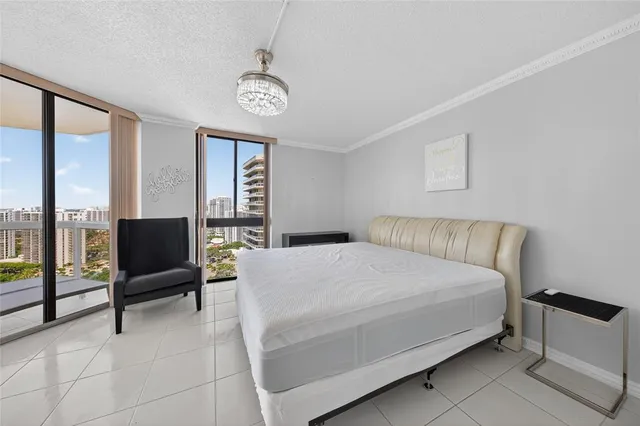 a bedroom with a large bed and a large window