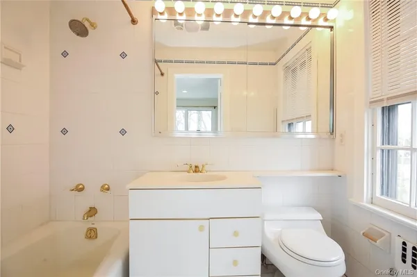 a bathroom with a sink a mirror and a bathtub