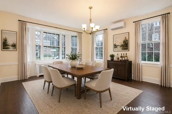 an empty room with windows and fireplace