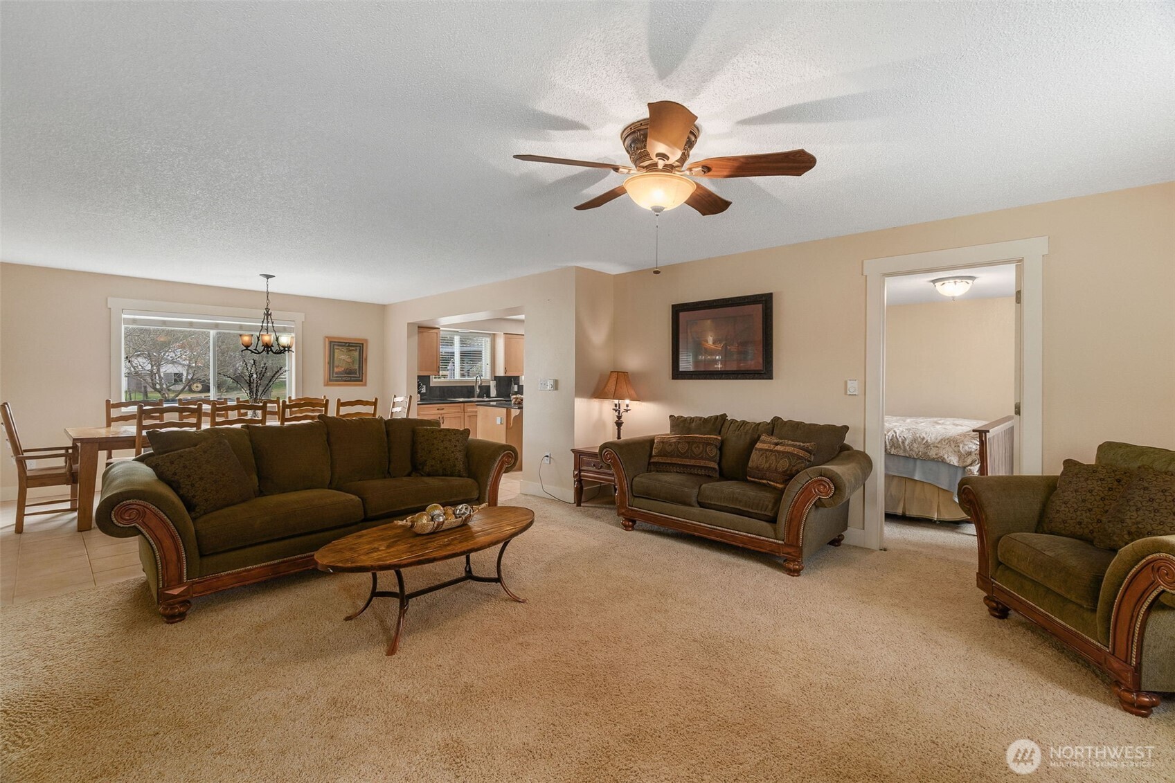 912 Middle Satsop Road Montesano, WA 98563 - Photo 21 of 36 a living room with furniture a ceiling fan a lamp and a window
