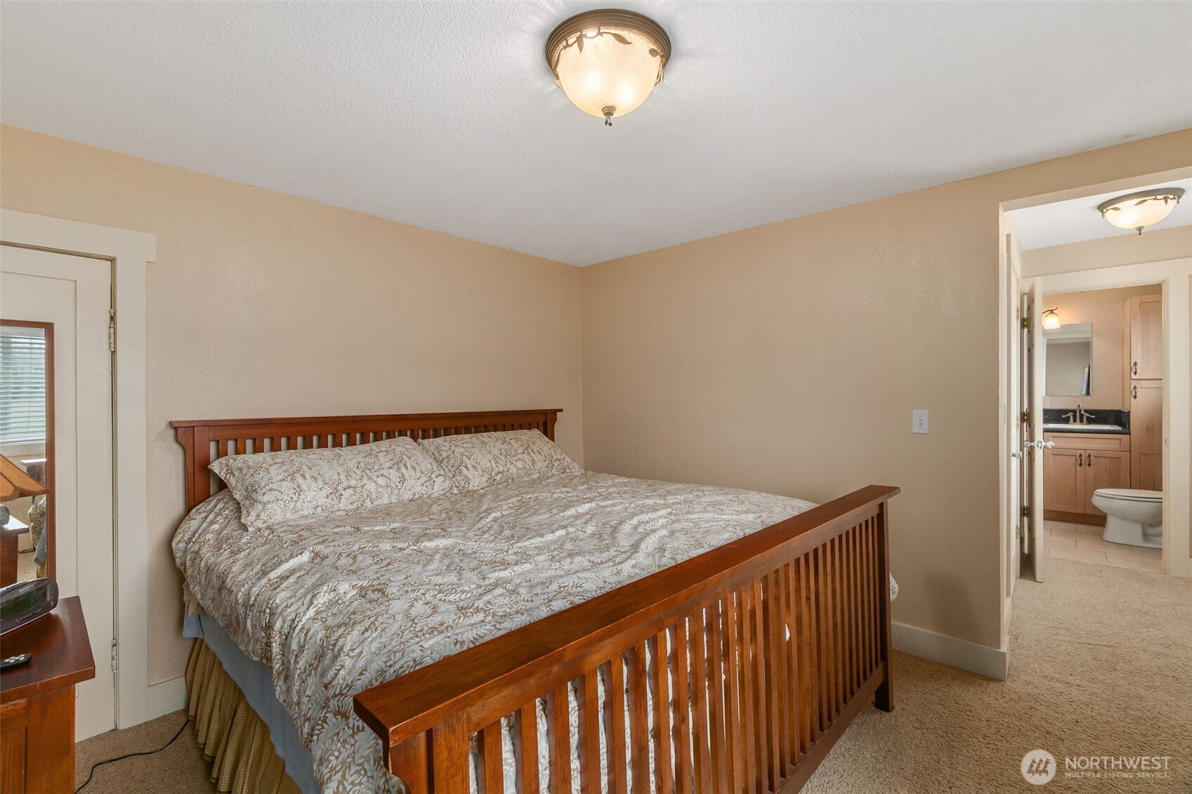 912 Middle Satsop Road Montesano, WA 98563 - Photo 28 of 36 a bed sitting in a bedroom next to a lamp