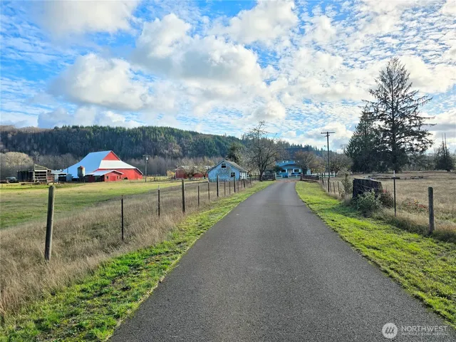 a view of a garden with wooden fence