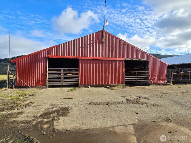 a view of wooden house and a garage
